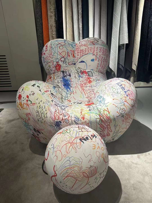 Colorful armchair with round stool